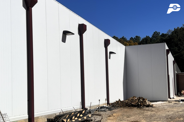 Modern insulated metal panel building exterior used for a climate-controlled warehouse or cold storage facility.