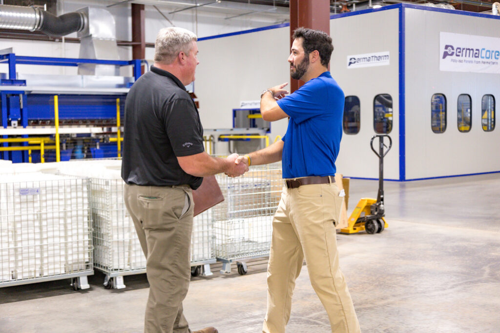 PermaTherm agent welcoming a client to the production area